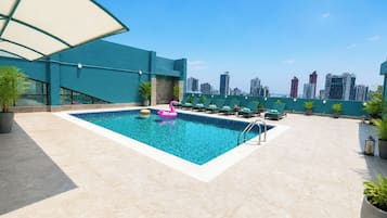 Outdoor pool, open 7:00 AM to 10:00 PM, pool umbrellas