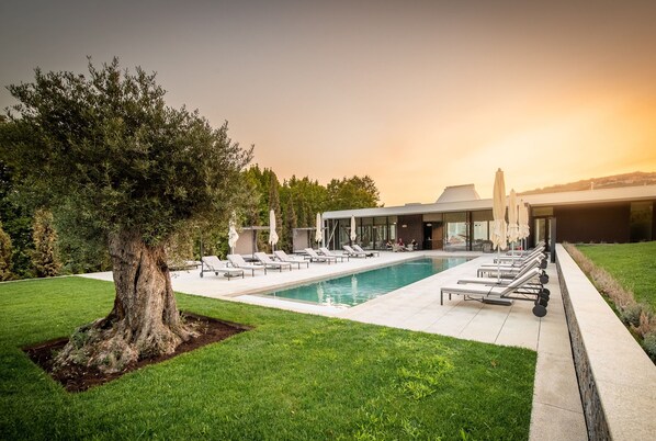 Seasonal outdoor pool, open 10:00 AM to 7:00 PM, pool umbrellas