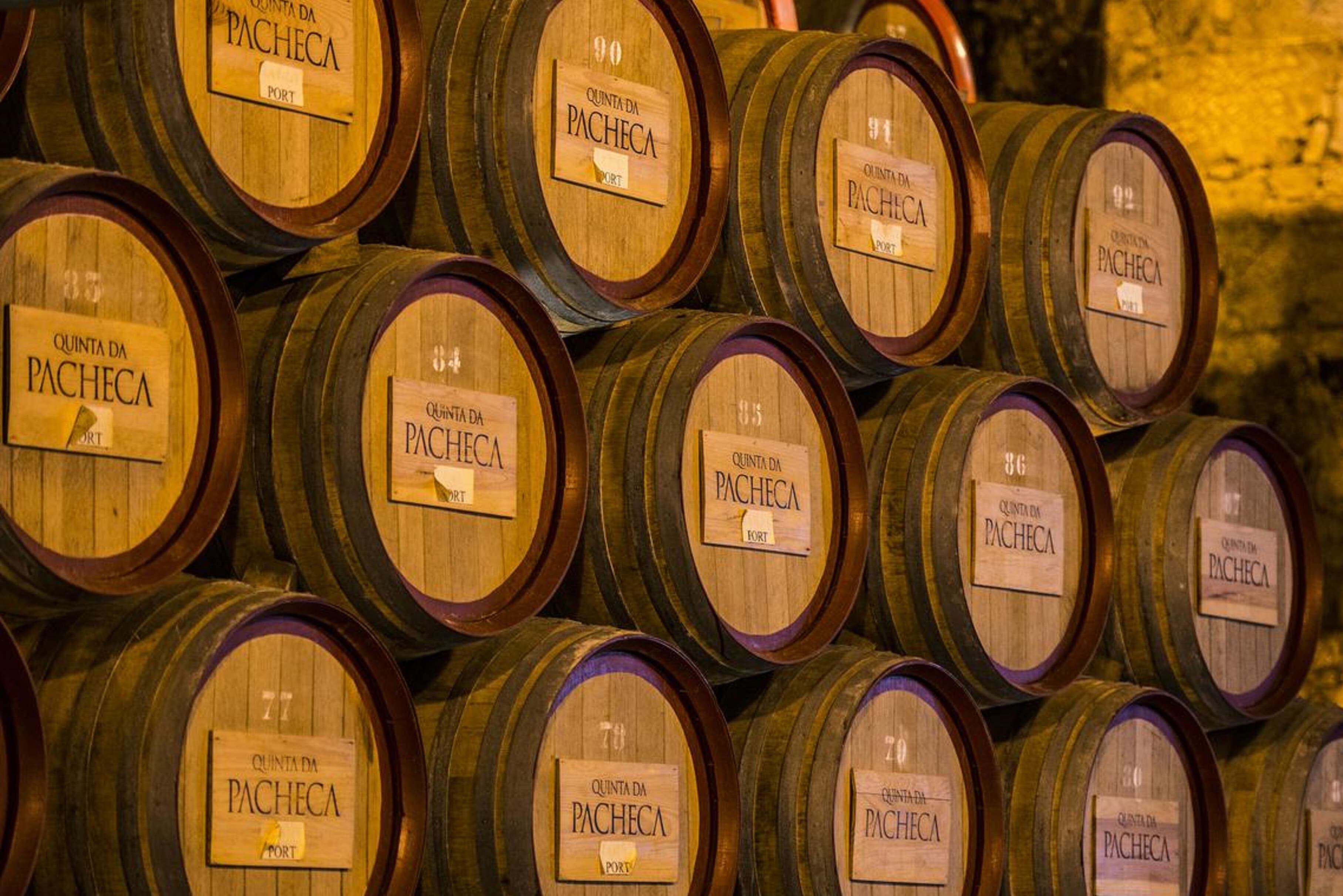 A stack of wooden barrels labeled "Quinta da Pacheca Port."