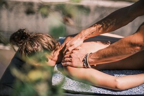 A person receiving a massage on a patterned mat. - Addo African Home (Addo)