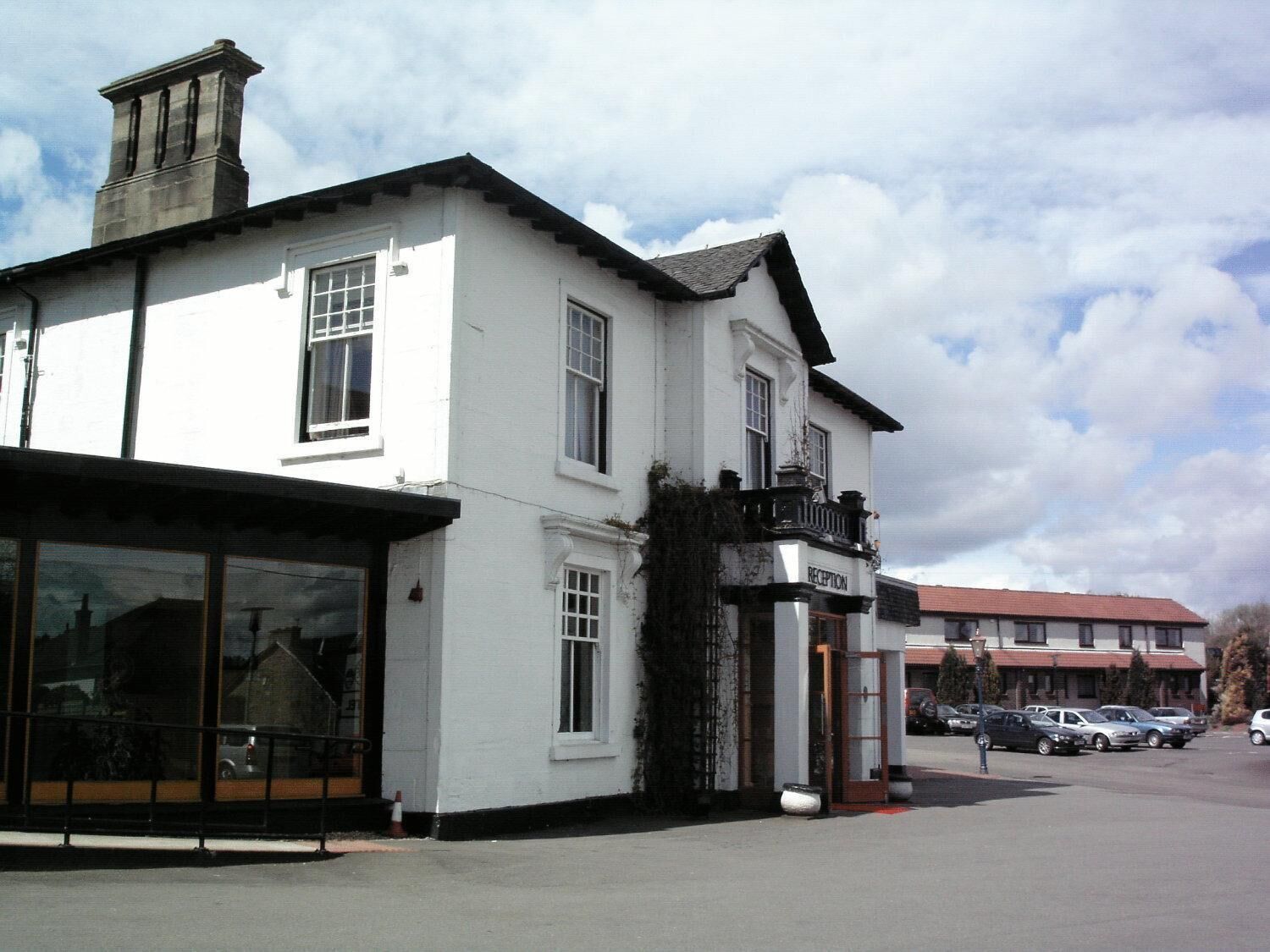 A white building with a reception area and large windows.
