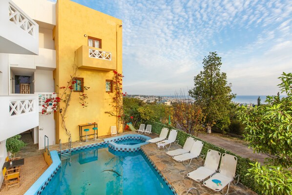 Seasonal outdoor pool, open 7:00 AM to 8:00 PM, pool umbrellas