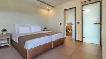A modern bedroom with a large bed, bedside tables, and a door leading to a bathroom.