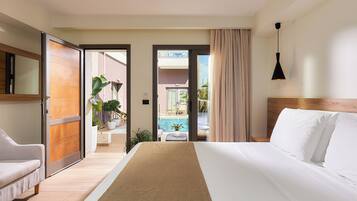 A hotel room with a bed, a sofa, a view of a pool, and a balcony.