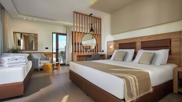 A modern hotel room with a large bed, a desk, and a chair. There is a large mirror and a window with curtains.