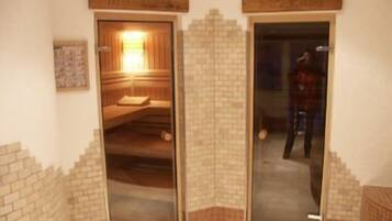 A sauna room with a wooden bench and a bench with a towel.