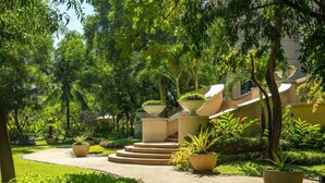 A well-maintained garden with a pathway leading to a building with a staircase. - Radisson Blu Cebu (Cebu City)