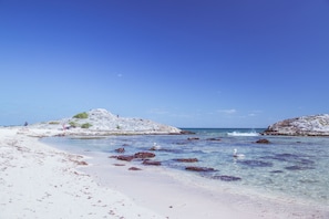 On the beach, sun-loungers, beach umbrellas, beach towels