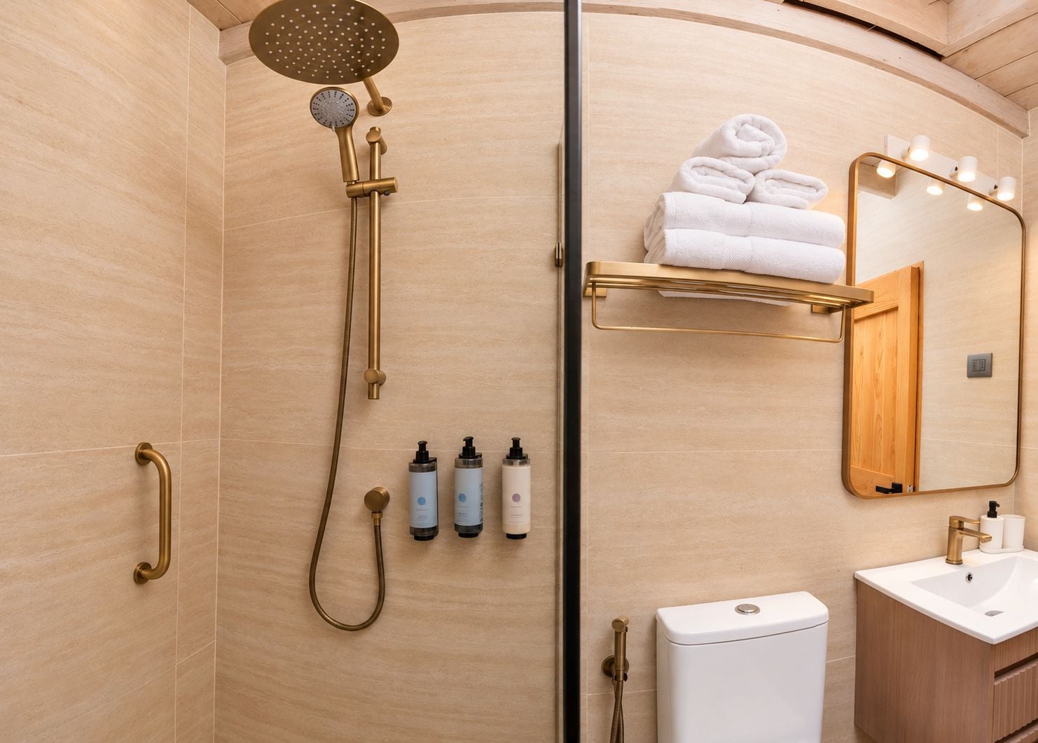 Un baño moderno con cabina de ducha, inodoro, lavabo y espejo con iluminación.