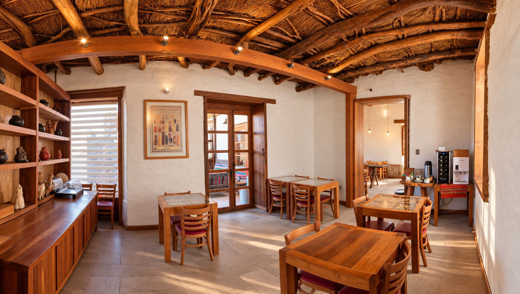 A rustic interior with wooden furniture, a thatched roof, and a dining area.