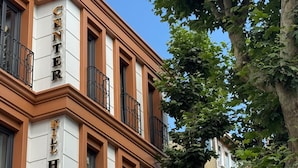A hotel with a classic architectural style, featuring a prominent 'CENTER HOTEL' sign on the facade.