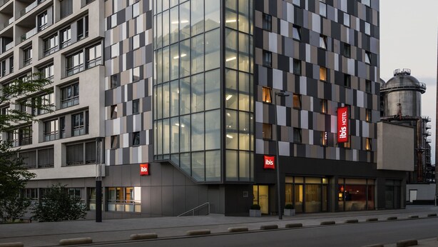 A modern hotel with a checkered facade, multiple balconies, and a prominent 'Ibis' sign. - ibis Esch Belval (Esch-sur-Alzette)