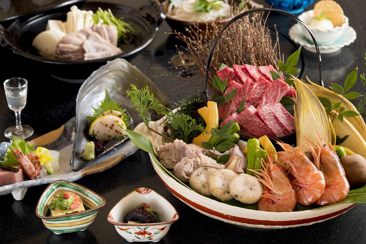 A variety of food items including seafood, vegetables, and meat, arranged on a table.