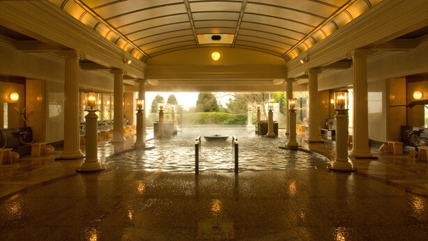 A spacious indoor area with a wet floor, suggesting recent rain. - Hyoe Koyokaku (Kobe)