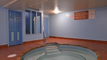 Swim and relax in our pool area, surrounded by a spacious tiled floor and offering a convenient exit to another room.