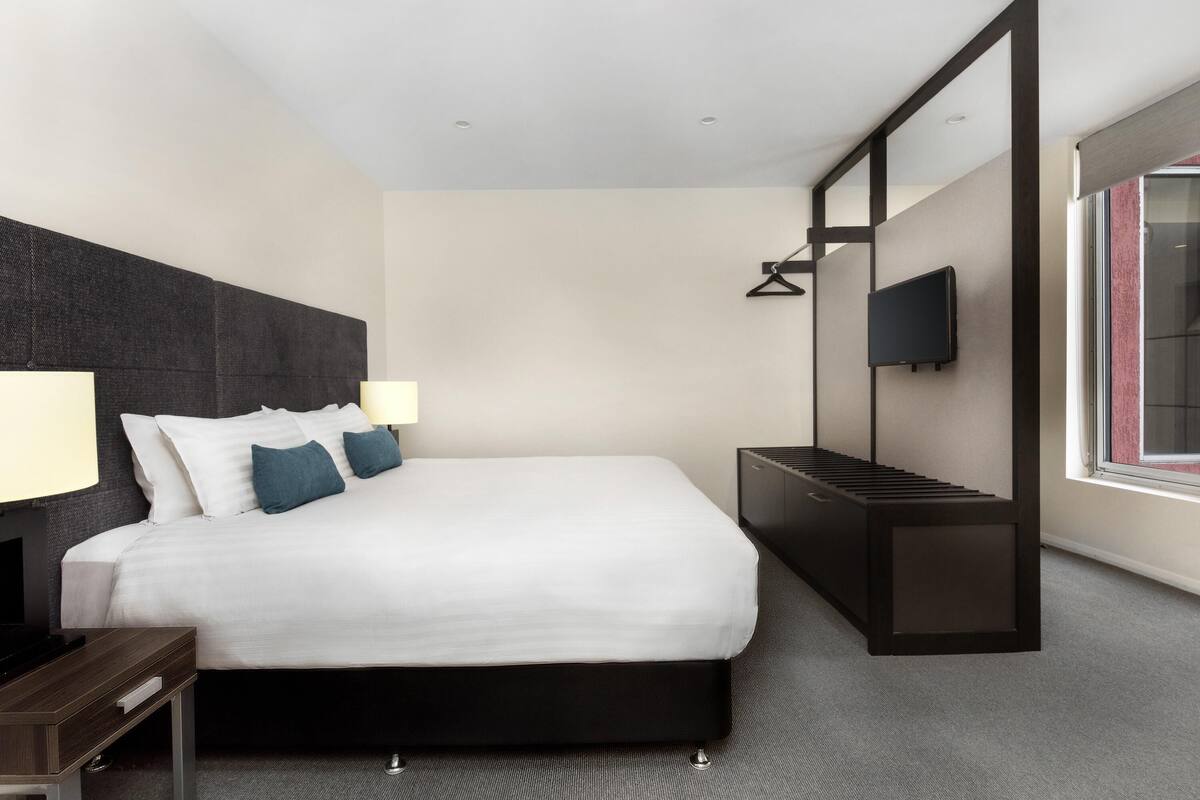 Apartment, 1 Bedroom | Minibar, soundproofing, iron/ironing board, WiFi