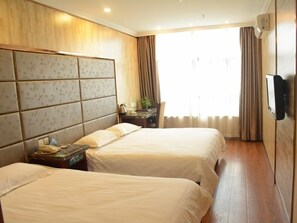 A hotel room with two beds, a wooden headboard, a flat-screen TV, and a large window with curtains. - GreenTree Inn Changzhou Xinbei District Taihu Road Wanda Square Express Hotel (Changzhou)