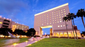 A hotel with a large entrance archway, multiple floors, and a well-lit facade. - Navios Yokohama (Yokohama)
