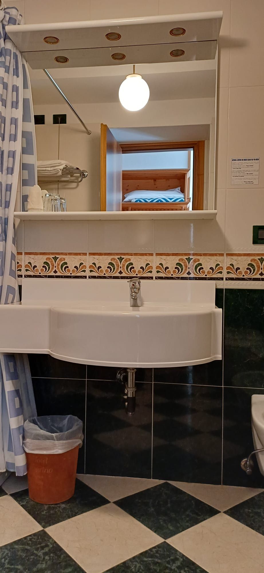 A bathroom with a sink, mirror, and a window with a view.