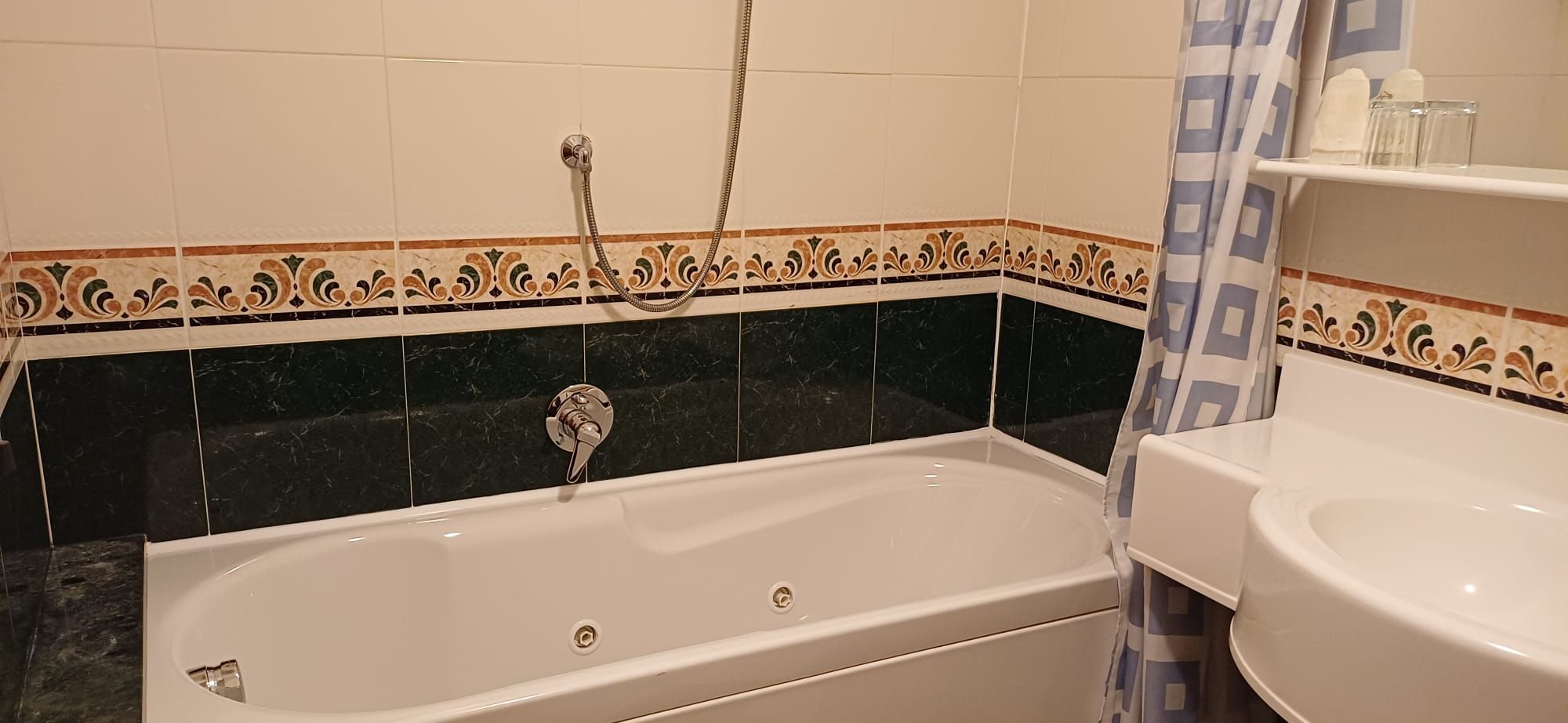 A bathroom with a bathtub, a shower, and a sink.