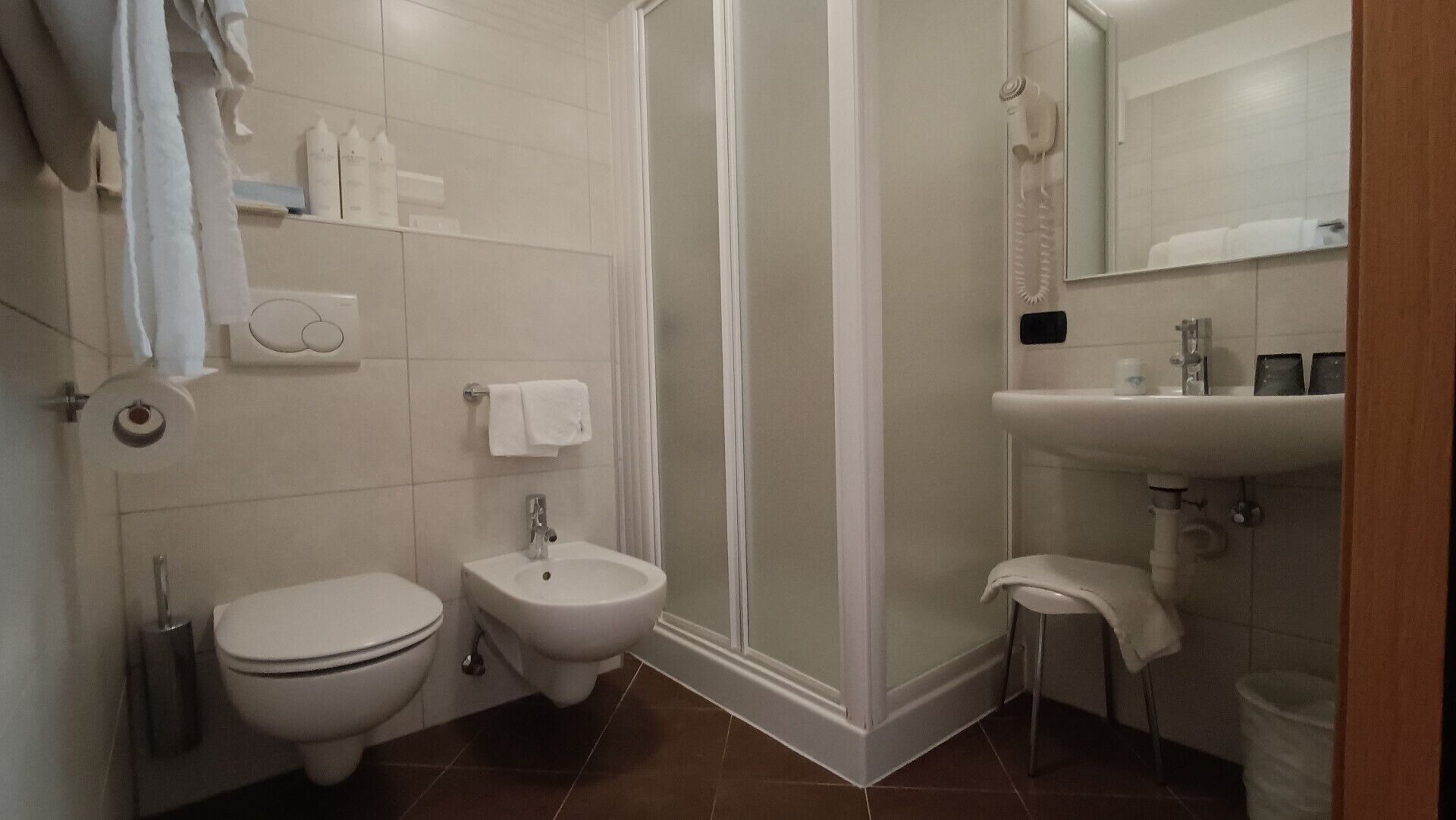A bathroom with a toilet, bidet, and sink.