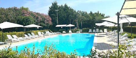 Outdoor pool, a waterfall pool, pool umbrellas, sun loungers