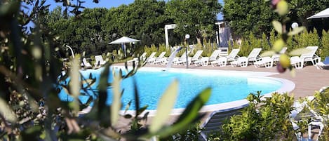 Outdoor pool, a waterfall pool, pool umbrellas, pool loungers