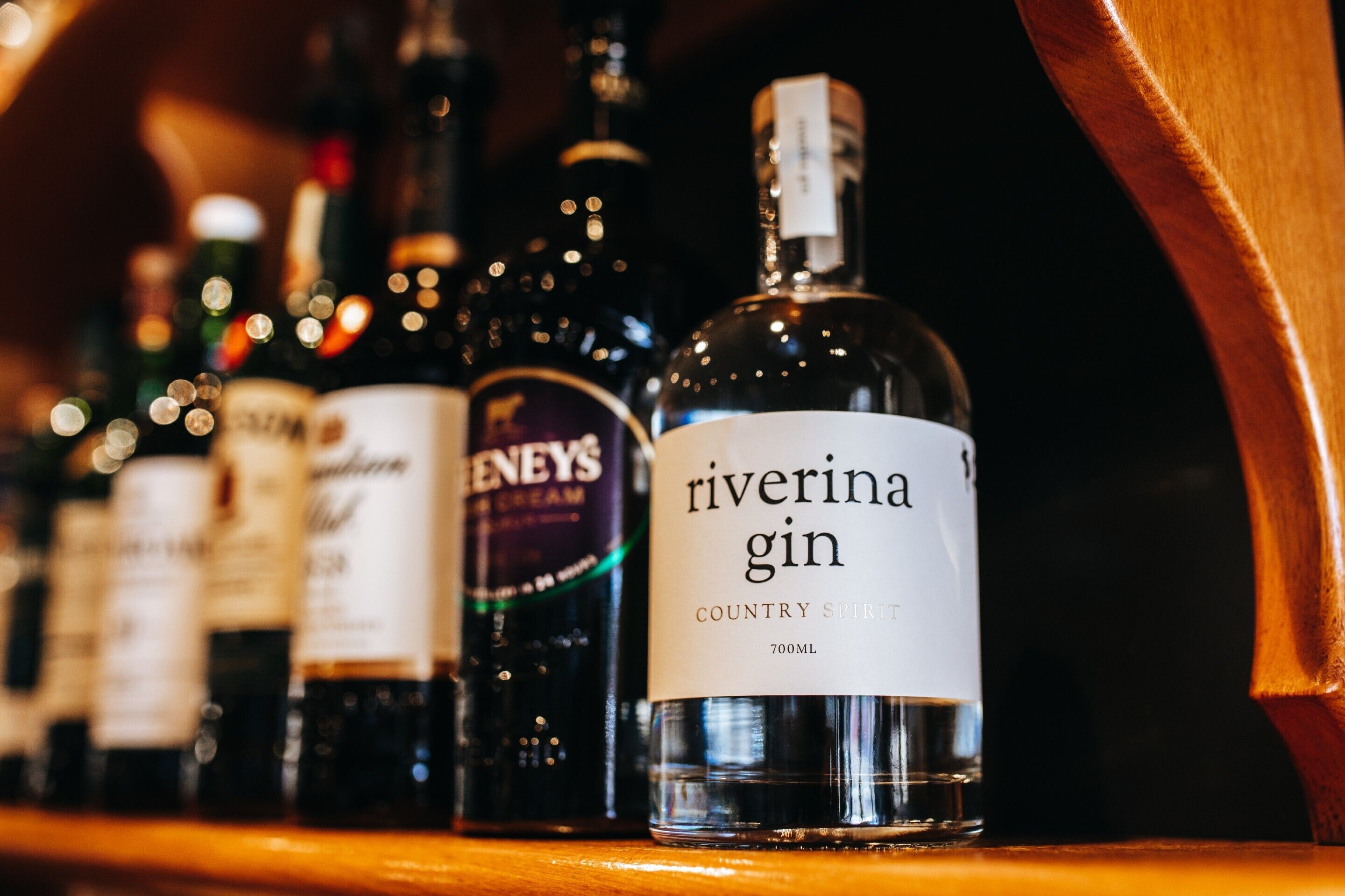 A selection of Riverina gin bottles on a shelf.