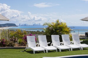 Outdoor pool, a heated pool, pool umbrellas, pool loungers