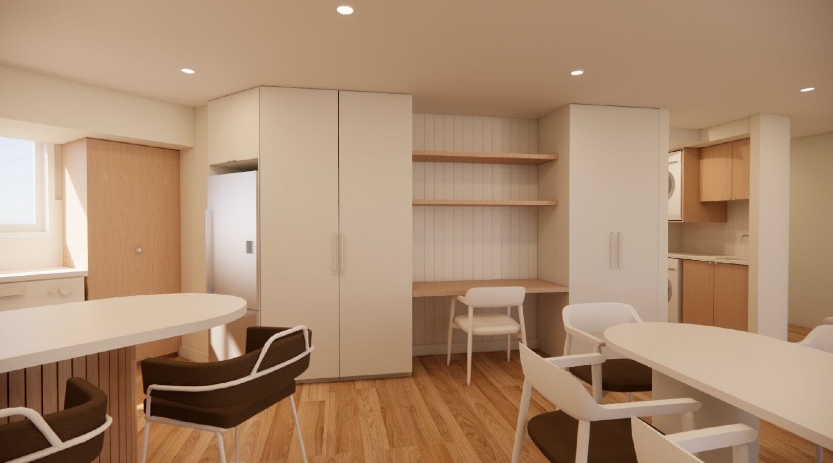 A modern, compact kitchen with white cabinetry, wooden countertops, and a built-in stove. There are two white dining tables with chairs, and a small window providing natural light.