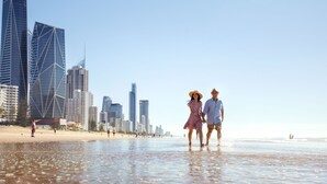 A beach with a city skyline in the background.