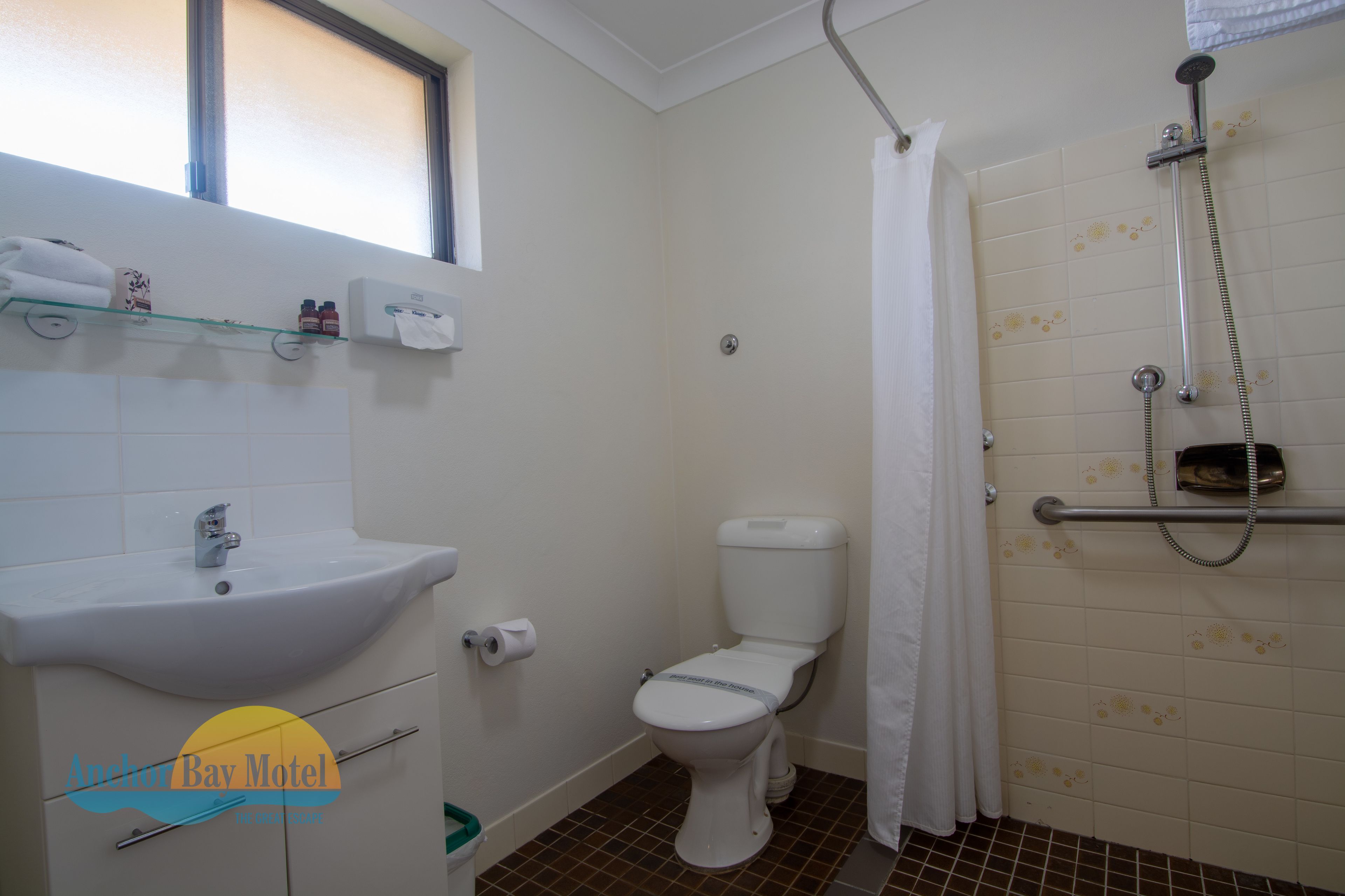 A bathroom with a sink, toilet, and shower.