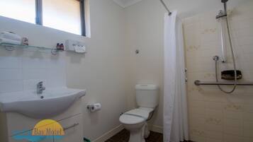 A bathroom with a sink, toilet, and shower.