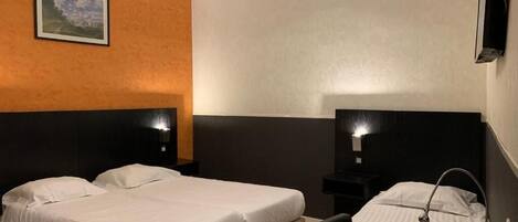A hotel room with two beds, a desk, a chair, a TV, and a painting on the wall.