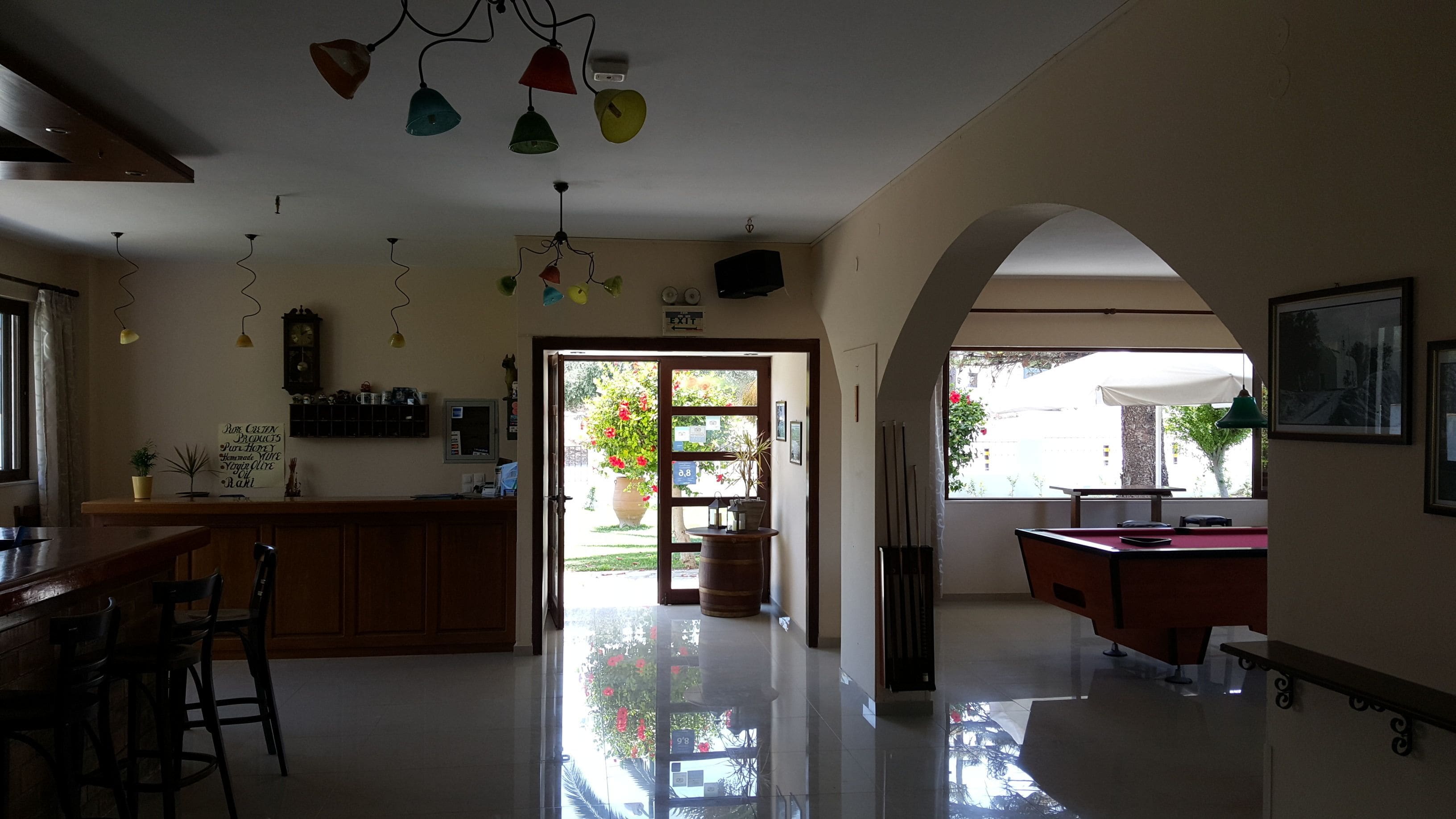 A spacious kitchen with a wooden counter, a bar area, and a large window providing natural light.