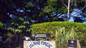 A sign for Island Magic Resort with a restaurant sign indicating it's open. - Island Magic Resort (Mele)
