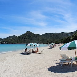 On the beach, white sand, beach umbrellas, beach towels