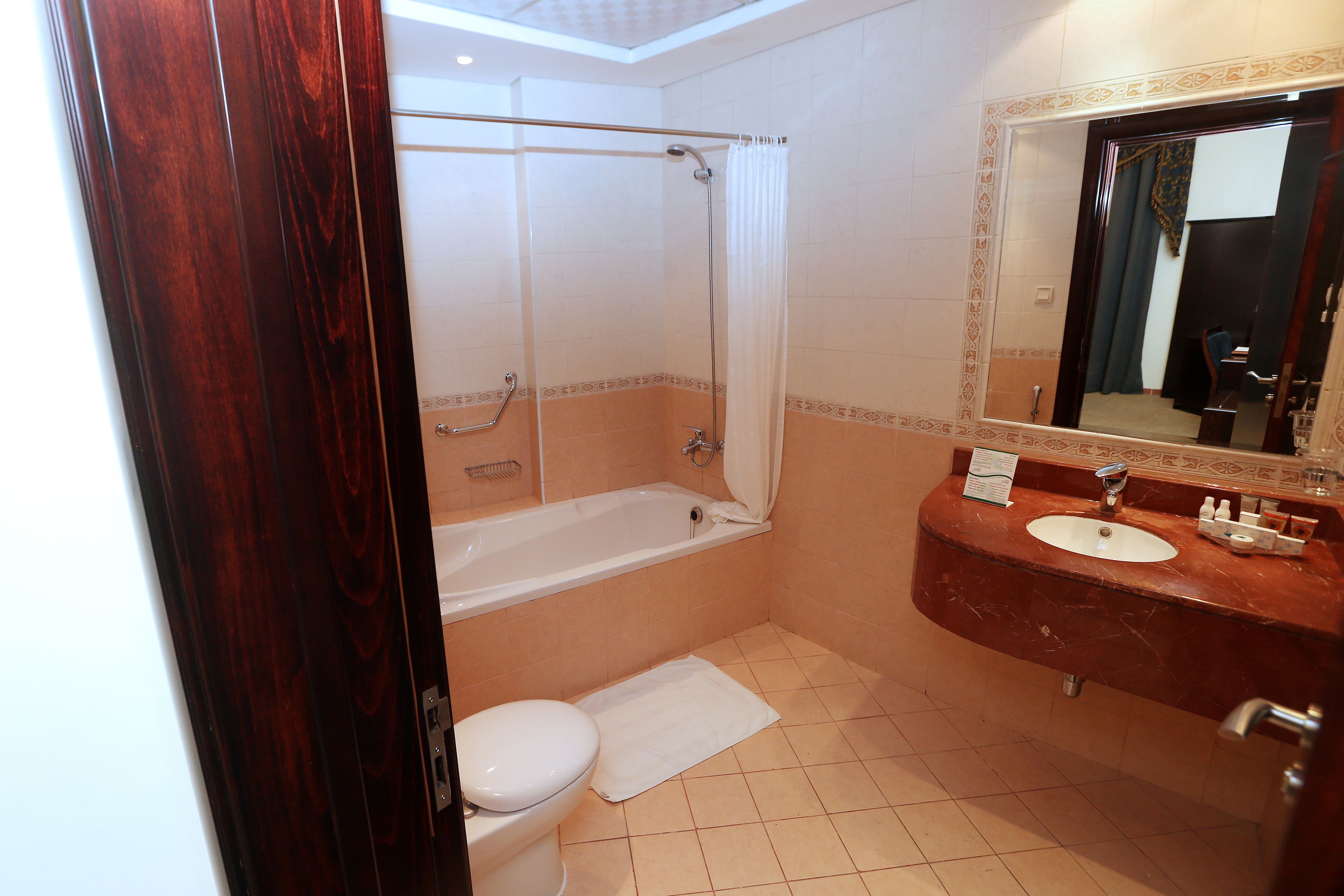 A bathroom with a bathtub, toilet, and sink.