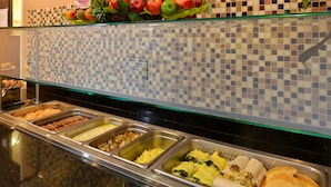 A buffet with various food options including pastries, eggs, and pancakes. - Holiday Inn Montgomery Airport South by IHG (Montgomery)