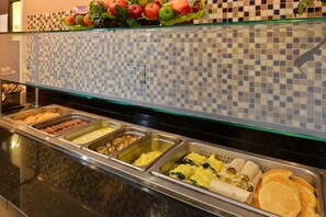 A buffet with various food options including pastries, eggs, and pancakes. - Holiday Inn Montgomery Airport South by IHG (Montgomery)