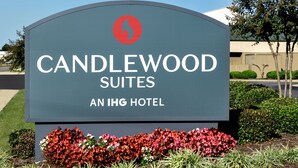 A sign for Candlewood Suites at an IHG hotel, featuring a logo and text. - Candlewood Suites Fayetteville Fort Bragg by IHG (Fayetteville)