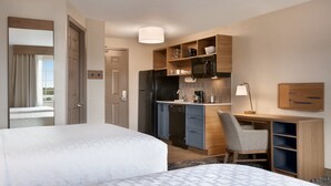 A hotel room with two beds, a kitchenette, a desk, and a chair. - Candlewood Suites Fayetteville Fort Bragg by IHG (Fayetteville)
