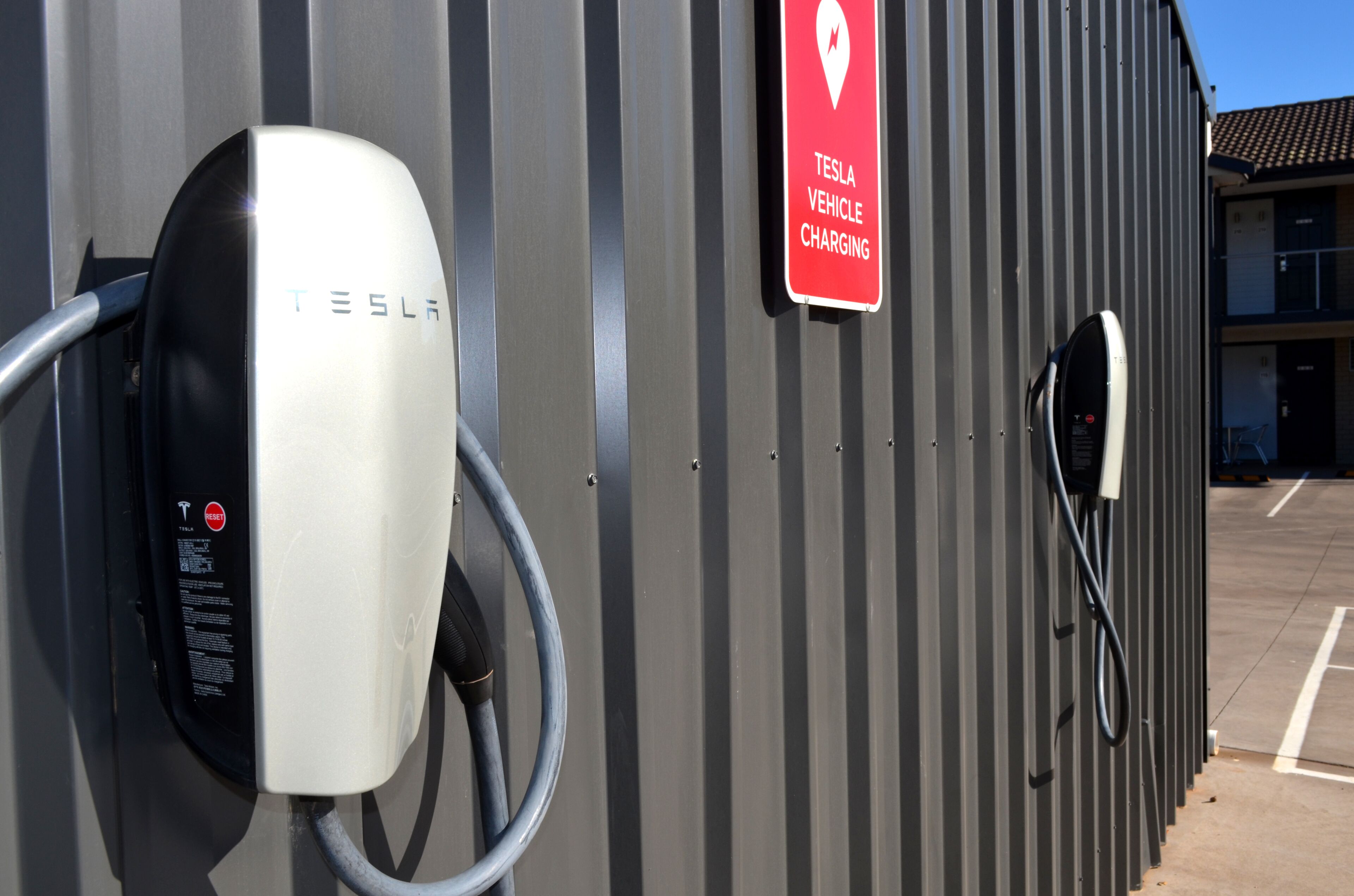 A Tesla vehicle charging station with a sign indicating it's for Tesla vehicle charging.