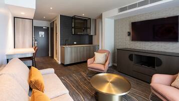 Superior Suite | Living area | 55-inch LCD TV with cable channels, TV, iPod dock