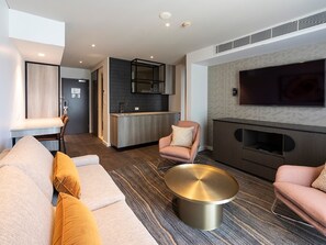 Superior Suite | Living area | 55-inch LCD TV with cable channels, TV, iPod dock - The Executive Inn (New Lambton)
