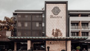 A modern building with a prominent vertical sign reading "The Executive Hotel." - The Executive Inn (New Lambton)