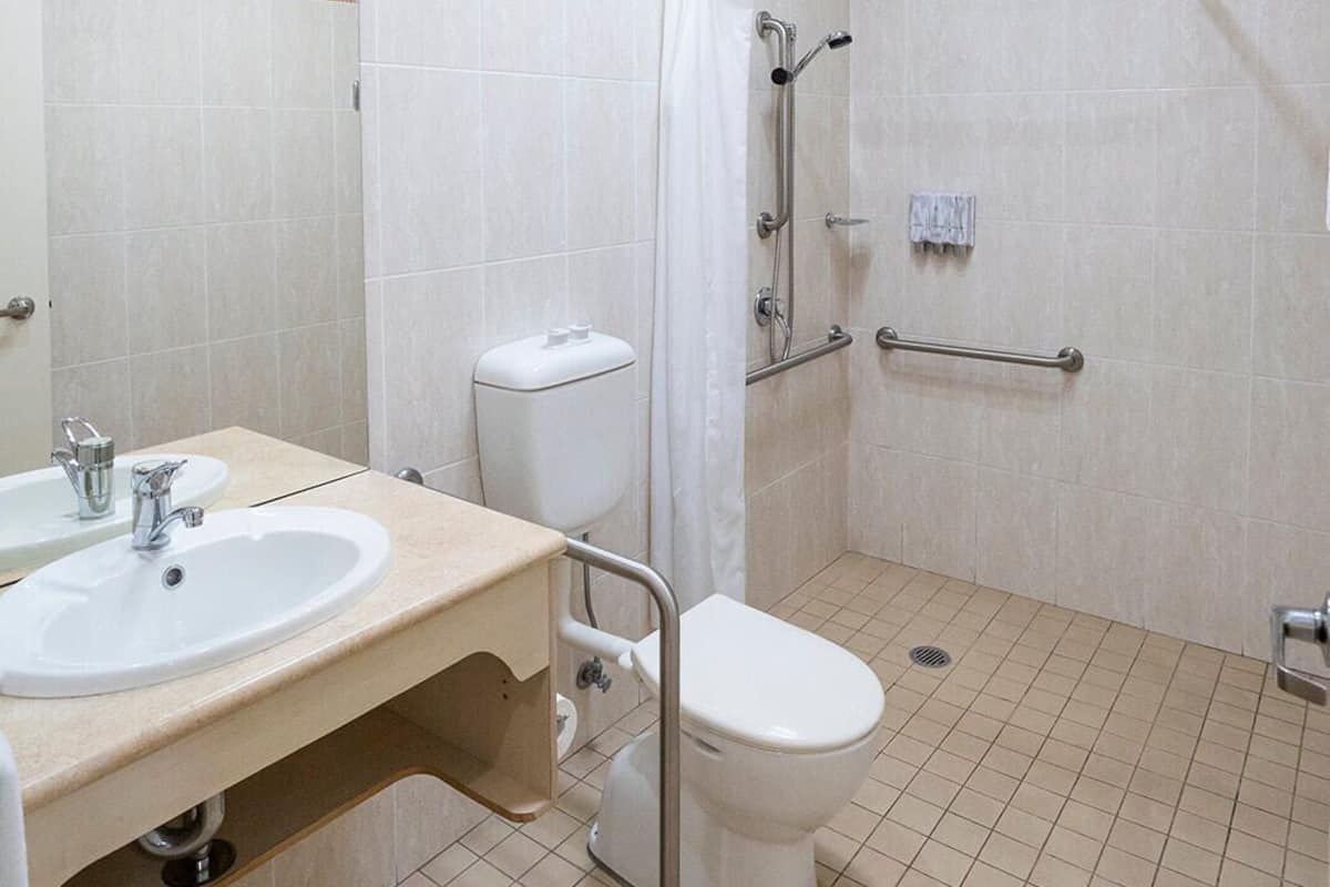 A bathroom with a sink, toilet, and shower.