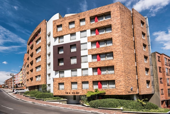 A multi-story hotel with a brick facade, multiple windows, and a prominent sign on the front. - Viaggio Urbano (Bogotá)