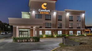 A Comfort Suites hotel with a modern design, featuring a prominent crescent moon logo on the facade. - Comfort Suites Natchitoches (Natchitoches)