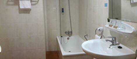 A bathroom with a bathtub, a sink, and a toilet.
